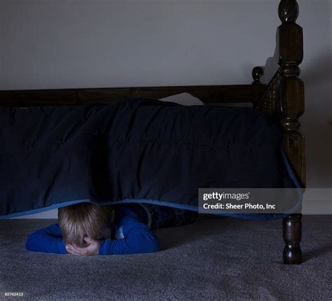 Boy Hiding Under Bed High Res Stock Photo Getty Images