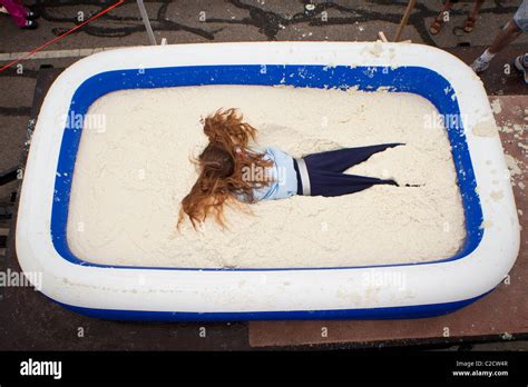A Participant In The Grits Roll Wallows In A Pool Of Grits During The Annual World Grits