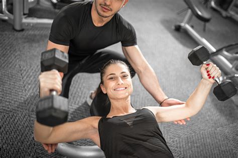 Woman Doing Fitness With Personal Trainer Help Stock Photo Download