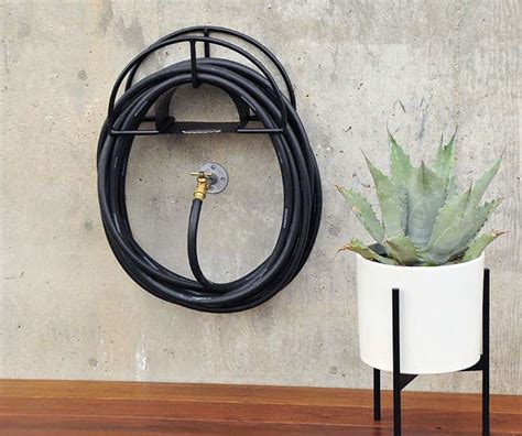 If the rather modest design of our last option didn't quite do it for you, you'll find that the liberty garden wall mount decorative hose hanger more than makes up for it with its beautifully elegant, ornate design. 10 Easy Pieces: Hose Hangers, from High to Low - The ...