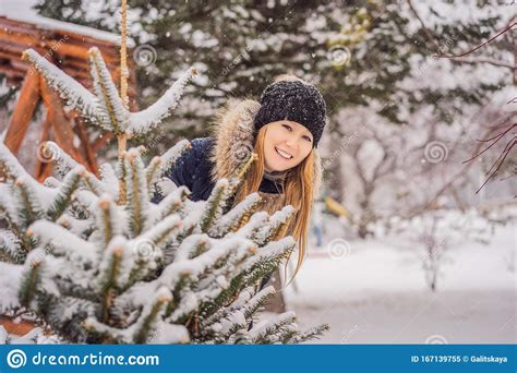 Young Woman Enjoys A Winter Snowy Day In A Snowy Forest Stock Image