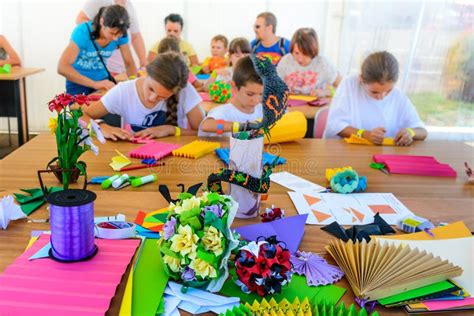 A Group Of Children Making Crafts Out Of Colored Paper Lifestyle Scene