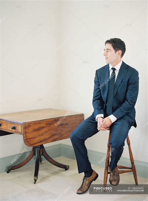 Man In Suit Sitting On Chair — Male Young Adult Stock Photo 156605656