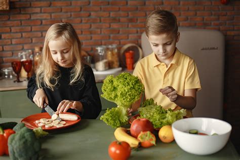Adorable children cutting with knife while preparing healthy food together · Free Stock Photo
