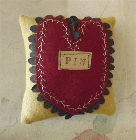 A Heart Shaped Pillow With The Word Pin On It