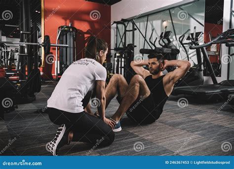 Young Trainer Instructing Handsome Sportsman Doing Stock Image Image