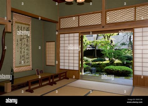 Shoji Sliding Screens Open To Sunny View Of Japanese Garden At