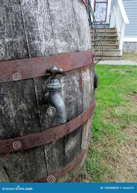 Modern Wooden Rain Barrel With Brass Spigot Used For Water Conservation