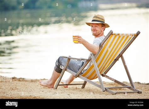 Relaxed Man Drinking Beer In Deck Chair In Summer Stock Photo 97800312