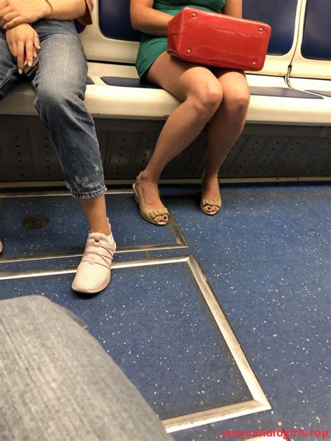 sexycandidgirls top milf in a short green dress in sandals sitting in the subway train candid