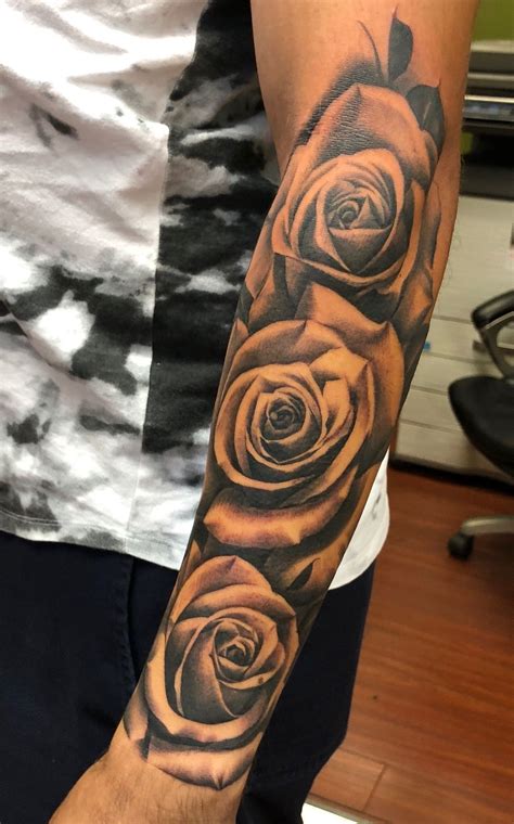 A Mans Arm With Three Roses On It