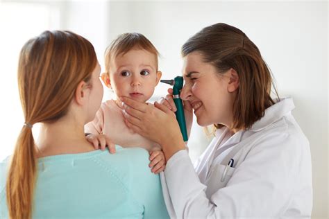 Doctor With Otoscope Checking Baby Ear At Clinic Heal Ca
