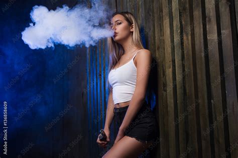 Cloud Of Smoke Sexy Girl Vapeing And Smoking Electronic Cigarette Smoking Vape Mod In A Sexy