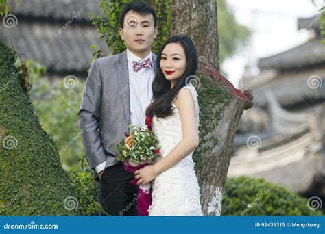 Chinese Couple Wedding Portraint In Front Of Old Trees And Old Building