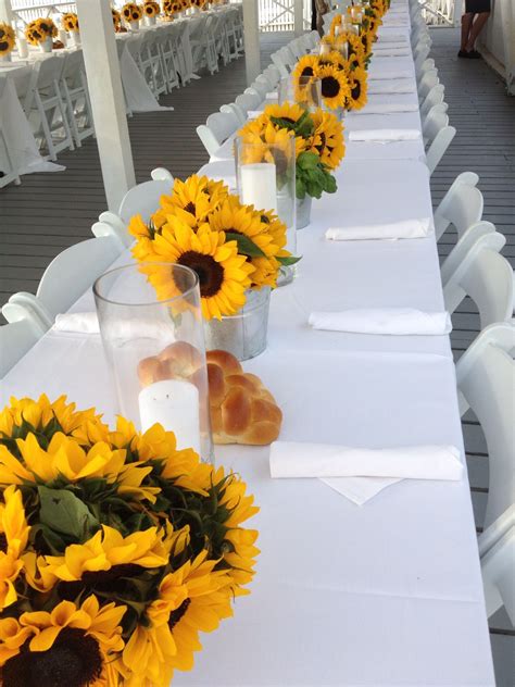 Place settings with sunflowers. Nice idea for rehearsal dinner or