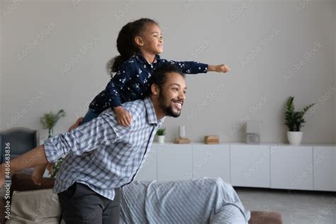 Happy African American Dad Piggybacking Excited Proud Daughter Kid
