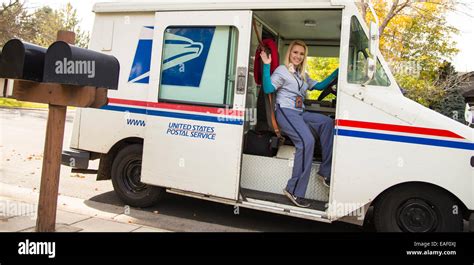 Female United States Postal Service Carrier Delivering Mail In Stock Photo Royalty Free Image