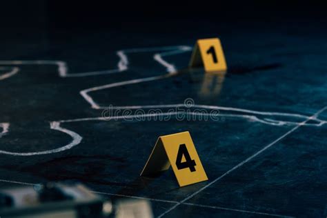 Selective Focus Of Chalk Outline And Evidence Markers Stock Photo