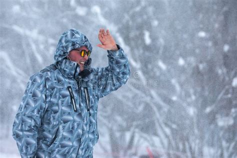 Man Stands Alone Against White Snowstorm And Snow Storm A Snowfall