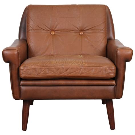 Floating within a slim antiqued finish steel frame with thick cushions and set at the perfect angle for repose. Danish Modern Brown Leather Chair by Skipper Mobler at 1stdibs