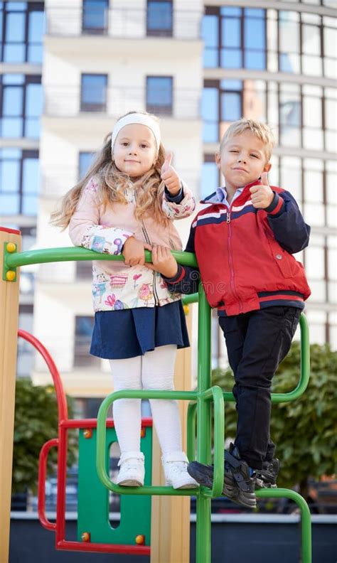 cheerful brother and sister having fun at playground stock image image of outside building