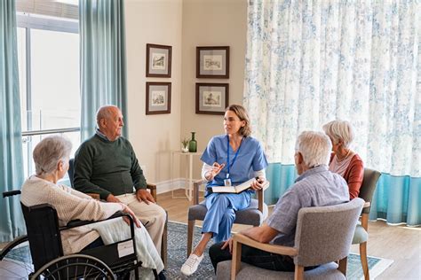 Nurse Talking To Senior People During Group Therapy Lancaster Cancer