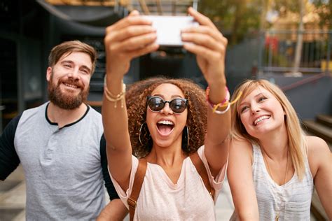Group Of Smiling Friends Taking Selfie With Smart Phone Brodsky