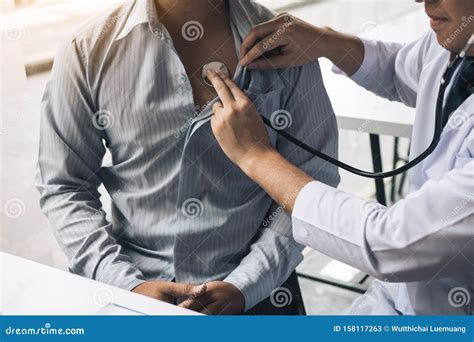 Asian Doctor Is Using A Stethoscope Listen To The Heartbeat Of The Elderly Patient Stock Image