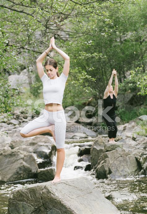 Woman And Man Doing Yoga In Nature Stock Photos