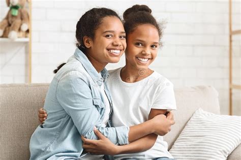 Two Lovely African American Sisters Hugging At Home Stock Image Image Of Love Affectionate