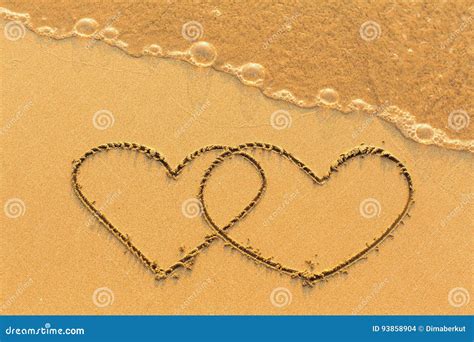 Two Hearts Drawn In The Sea Sand With The Soft Wave Love Stock Photo