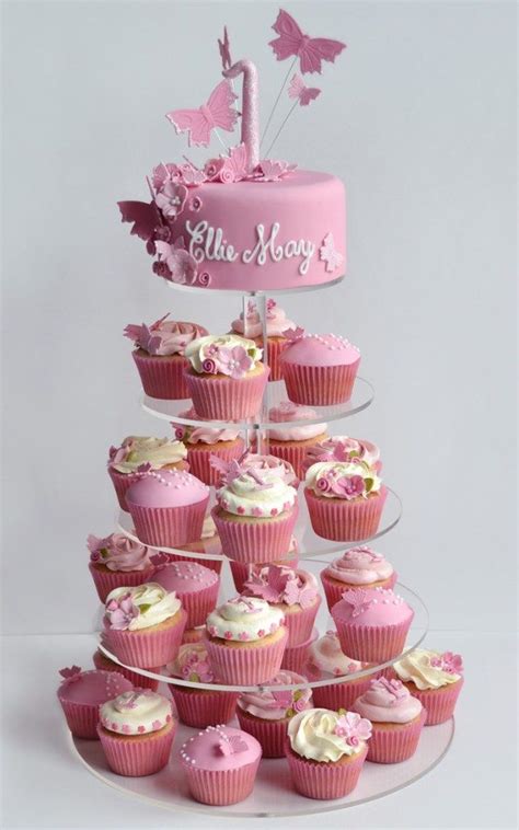 Cupcakes Are Arranged In The Shape Of A Tower With Pink Frosting And