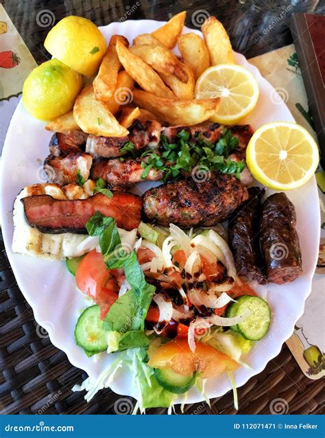 Plate Of Traditional Greek Meat Souvlaki With Potato And Salad Stock