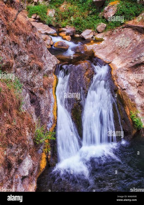 Small Waterfall On Jenolan River Between Sandstone Rocks In Blue