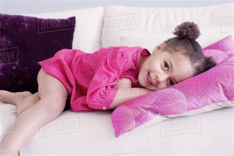 Little Girl Lying On Couch Stock Photo Dissolve