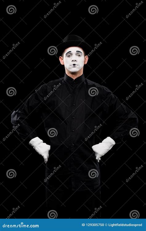 Mime Standing With Hands Akimbo And Looking At Camera Stock Photo