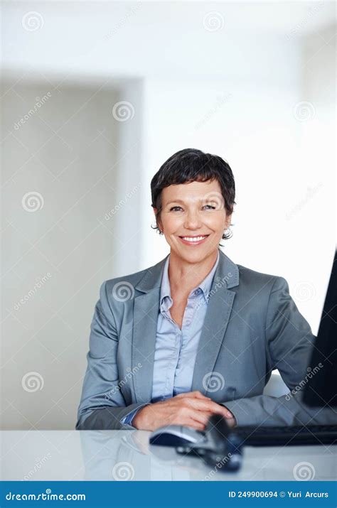 Mature Female Executive At Office Desk Portrait Of Mature Female