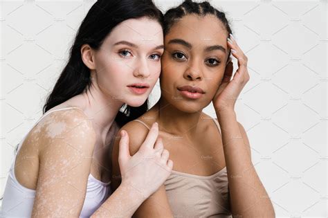 Two Young Diverse Women Posing Together Over People Images ~ Creative