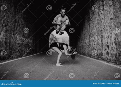 Smiling Man Jumping Over His Girlfriend While Playing On A Road Black And White Stock Image