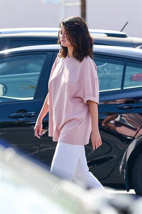 Selena Gomez Wears An Oversized Pink T Shirt And White Sweatpants