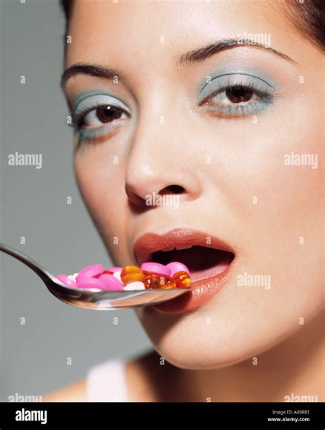 Woman Eating Spoon Of Tablets Stock Photo Alamy