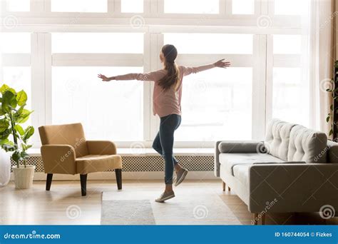 Happy Active Young Woman Dancing Alone In Modern Living Room Stock