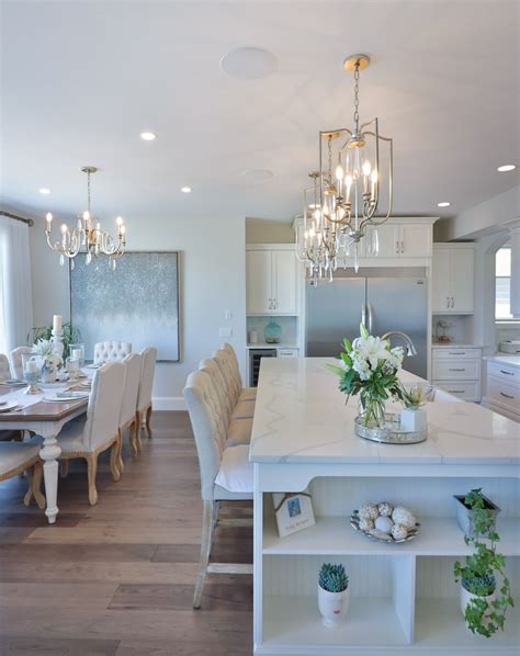 Three Pendants Over Kitchen Island And Complimentary Chandelier Over