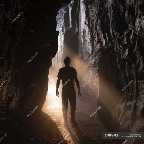 Man Standing In Cave — Silhouette Shadow Stock Photo 124541028