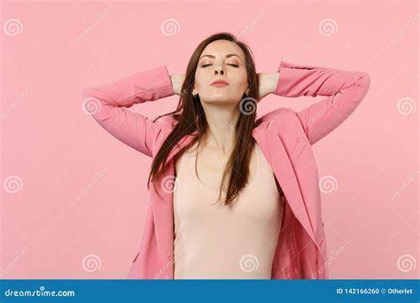Portrait Of Relaxed Woman Wearing Jacket Keeping Eyes Closed Holding Hands Behind Head Isolated