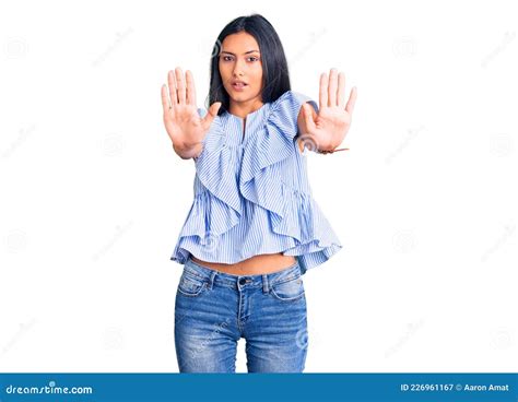 Young Beautiful Latin Girl Wearing Casual Clothes Doing Stop Gesture