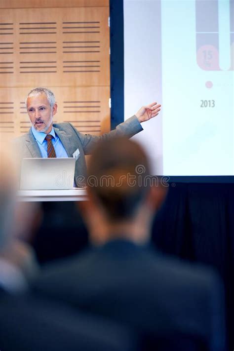 Making Sure The Facts Are Clear A Mature Businessman Gesturing While Giving A Presentation At A