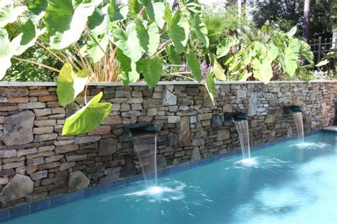 Pool With Spa And A Stone Wall With Waterfalls Aqua Blue Pools