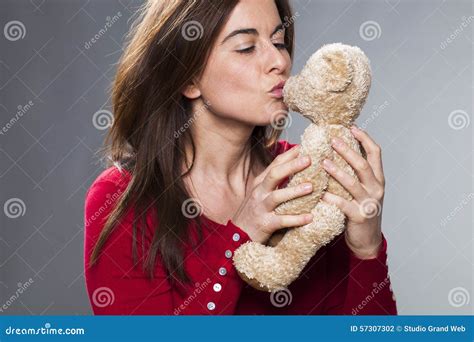 Older Attractive Lady Blowing Her Cuddly Toy A Kiss Stock Photo Image