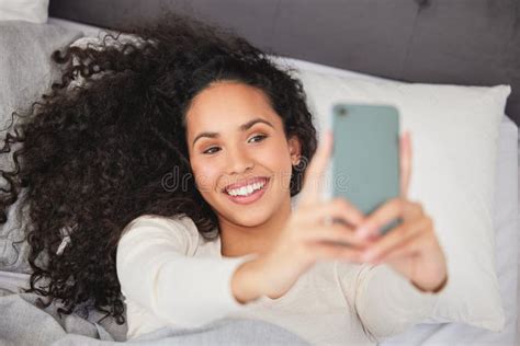An Early Morning Selfie Is A Blessing For The Whole Day A Young Woman Laying In Bed And Using